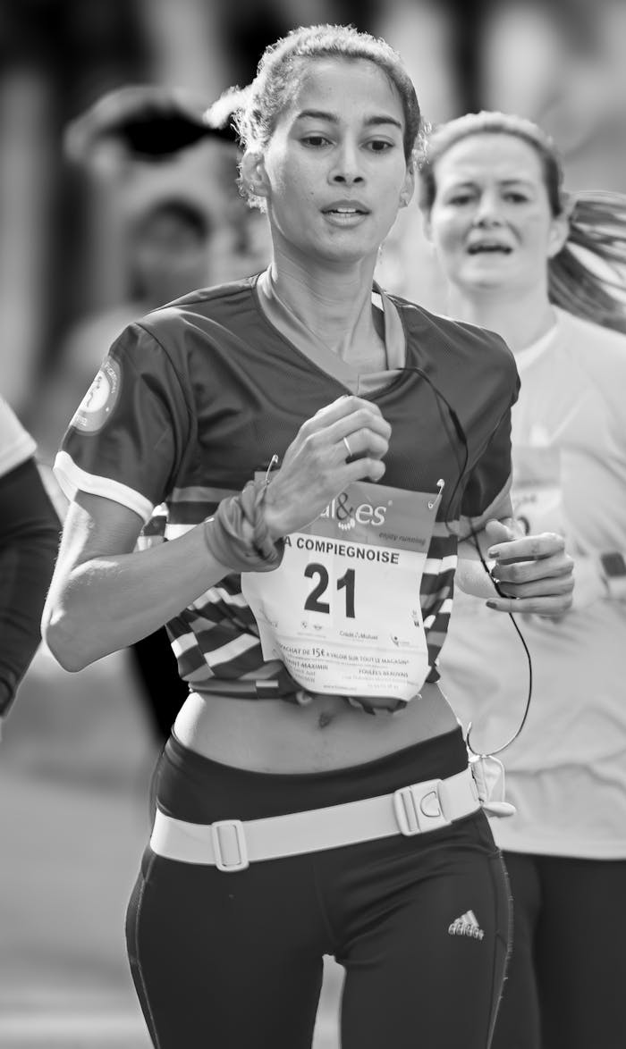 Powerful black and white photo of women in a marathon, capturing motion and determination.