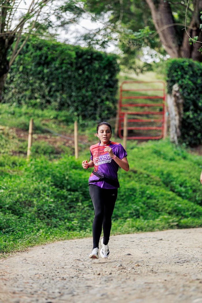 A young woman running on a nature trail in Toro, Valle del Cauca, Colombia.
